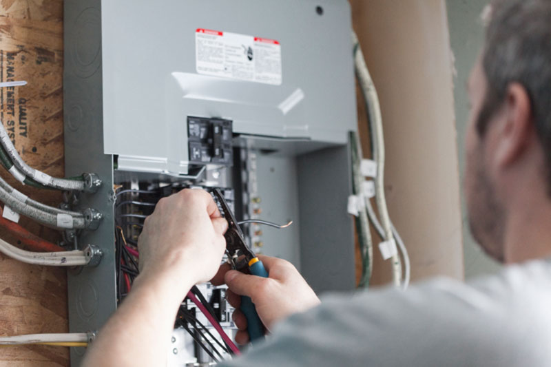 Electrician working on upgrading a homes breaker box