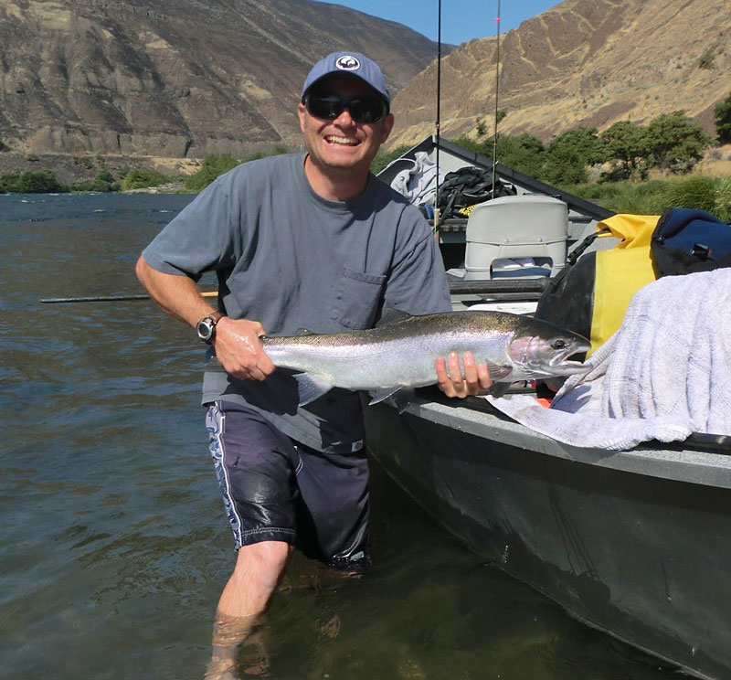 owner of Steelhead electric service hold a fish he caught